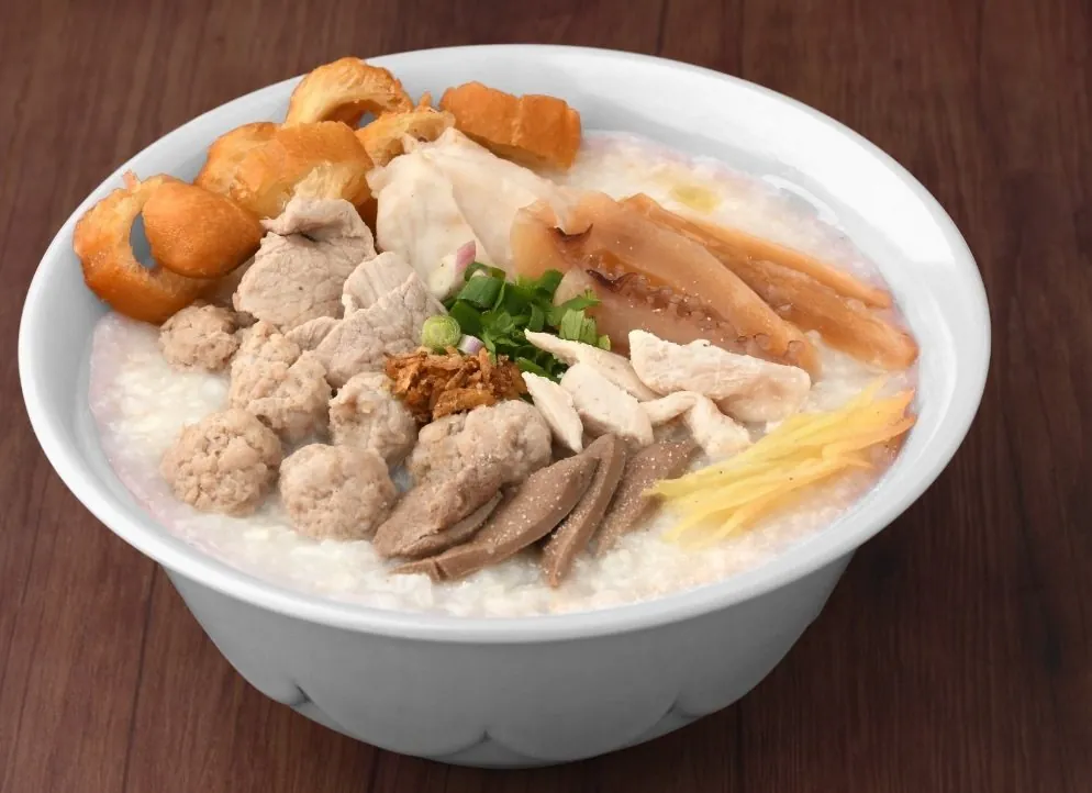 A bowl of Ming Kee porridge with spring onion and youtiao